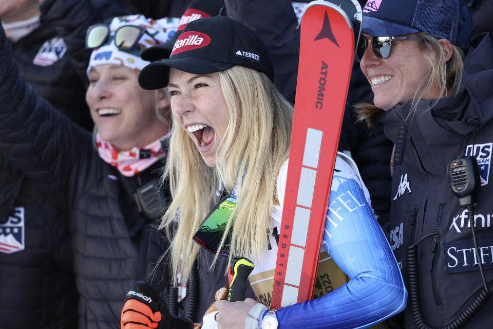United States' Mikaela Shiffrin celebrates with her team after winning gold in an alpine ski World Championships giant slalom, in Meribel, France, Thursday, Feb. 16, 2023. (AP Photo/Alessandro Trovati)