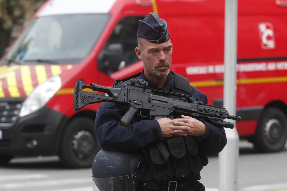 A police officer stands guard after a man armed with a knife killed a teacher and wounded two others at a high school in northern France, Friday, Oct. 13, 2023 in Arras. Antiterror prosecutors said they were leading the investigation into the attack at the Gambetta high school in the city of Arras, some 115 miles (185 kilometers) north of Paris. (AP Photo/Michel Spingler)