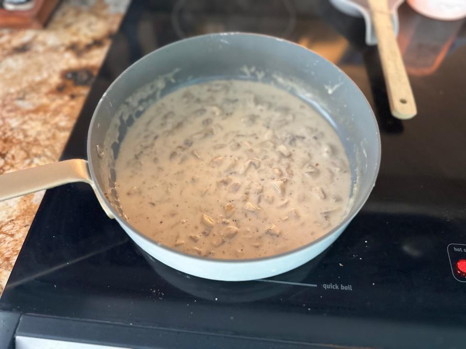 mushroom sauce for alton brown's green bean casserole cooking in a pot on the stove