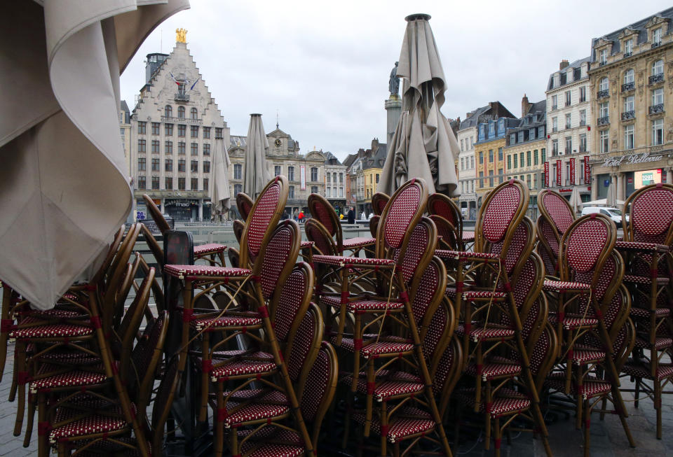 Chairs are stacked up outside an empty restaurant in the center of Lille, northern France, Sunday March 15, 2020. French Prime Minister Edouard Philippe announced that France is shutting down all restaurants, cafes, cinemas and non-essential retail shops, starting Sunday, to combat the accelerated spread of the virus in the country. For most people, the new coronavirus causes only mild or moderate symptoms. For some it can cause more severe illness. (AP Photo/Michel Spingler)