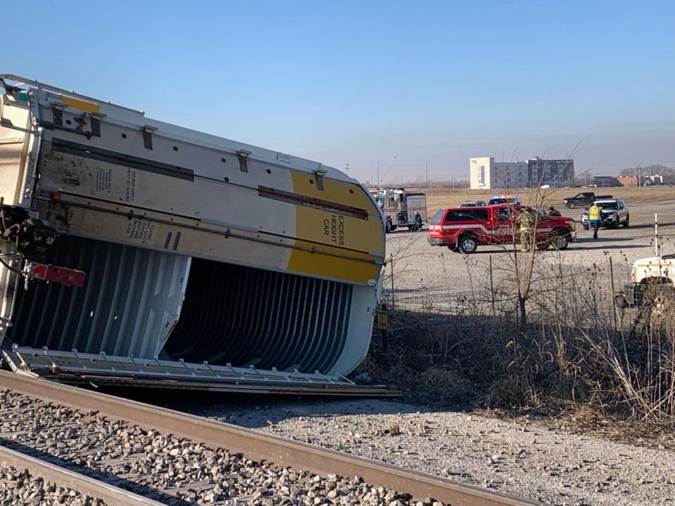 Emergency personnel respond to a partially-derailed freight train Friday morning near Scheels.