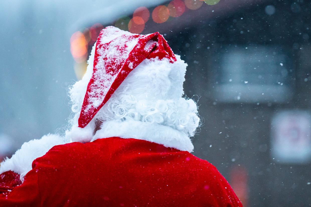 Snow falls on Santa Claus during the Holiday Lights at the Lake, Thursday, Nov. 17, 2022, at the West Overlook Campground in Coralville, Iowa.