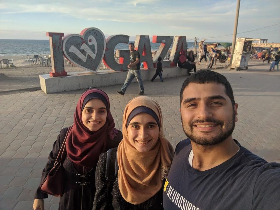 Yamaan Saadeh, right, stands with his sisters Huda and Heba during a visit to Gaza in 2018.