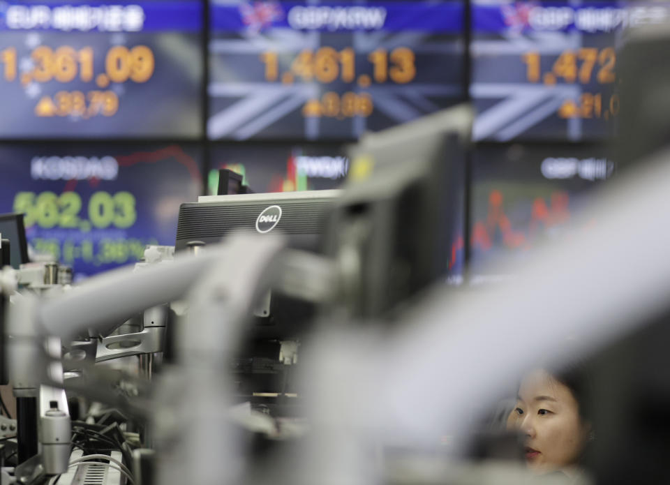 A currency trader watches the computer monitors at the foreign exchange dealing room in Seoul, South Korea, Tuesday, Aug. 6, 2019. Asian stocks followed Wall Street lower on Tuesday after China let its currency sink and halted purchases of U.S. farm goods, fueling fears Beijing's trade war with President Donald Trump will harm the global economy. (AP Photo/Lee Jin-man)