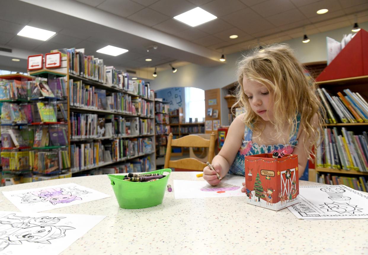 Layla Boyd, 6, of Jackson Township creates a masterpiece on Monday, April 1, 2024, at Massillon Public Library.