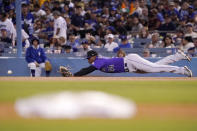 Colorado Rockies first baseman Elehuris Montero can't get to a ball hit for a single by Los Angeles Dodgers' Cody Bellinger during the seventh inning of a baseball game Friday, Sept. 30, 2022, in Los Angeles. (AP Photo/Mark J. Terrill)