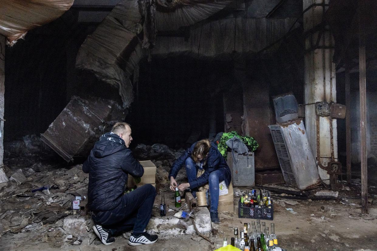 Volunteers work to make molotov cocktails in the basement of a bomb shelter on Feb. 26, 2022, in Kyiv, Ukraine.