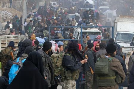 Rebel fighters and civilians gather as they wait to be evacuated from a rebel-held sector of eastern Aleppo, Syria December 16, 2016. REUTERS/Abdalrhman Ismail