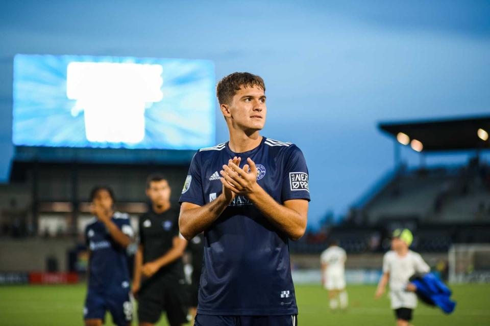 Forward Adem Sipic applauds fans of Huntsville City FC, the MLS Next Pro club affiliated with Nashville SC.