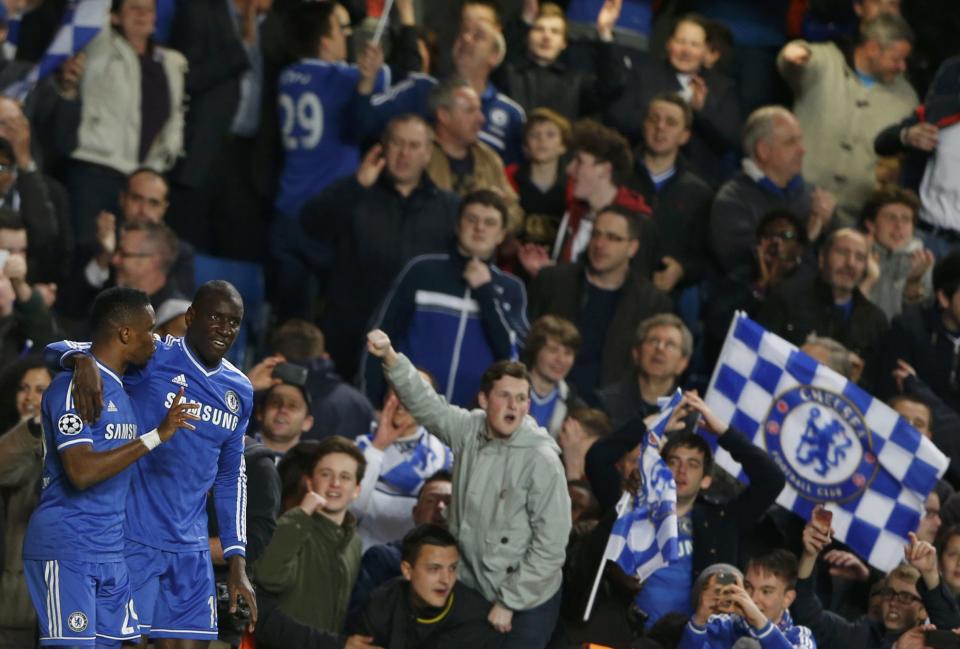 Chelsea's Demba Ba celebrates with team mate Samuel Eto'o at the end of their Champions League quarter-final second leg soccer match against Paris St Germain at Stamford Bridge in London