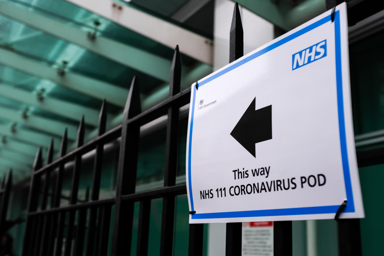 A sign directs patients towards an NHS 111 Coronavirus (COVID-19) Pod, where people who believe they may be suffering from the virus can attend and speak to doctors, at London University Hospital in London on March 5, 2020.  (Photo by Alberto Pezzali/NurPhoto via Getty Images)