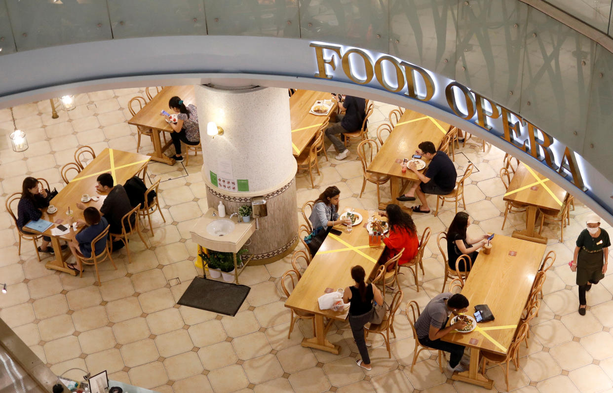 Tables and chairs are taped up to encourage social distancing, due to the COVID-19 outbreak, at a food court here on 25 March, 2020. (PHOTO: Reuters)