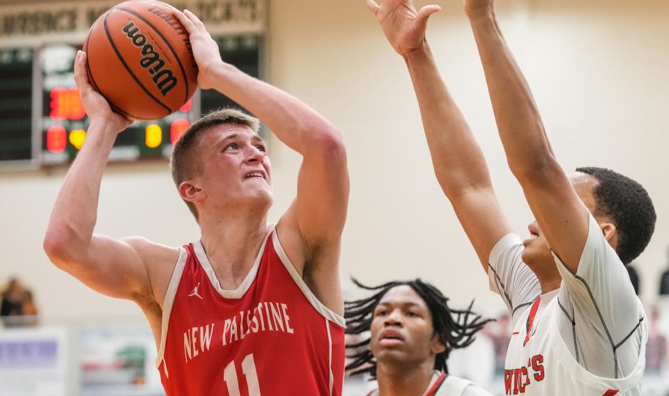 New Palestine Dragons guard Julius Gizzi (11) goes in for a lay-up Wednesday, Jan. 24, 2024, during the game at Lawrence North High School in Indianapolis. The Lawrence North Wildcats defeated the New Palestine Dragons, 57-48.