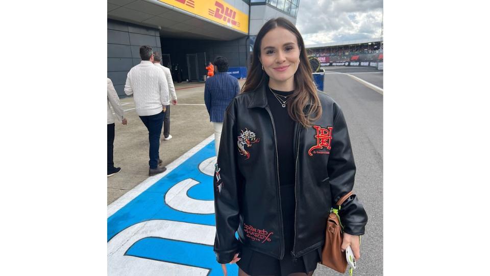 lady wearing black outfit at motor car circuit