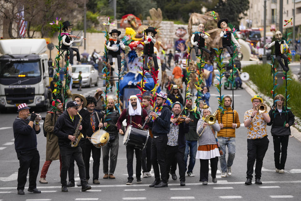 Performers play music during Purim parade in Jerusalem, Monday, March 25, 2024. For the first time after 42 years and amid the Israel-Hamas war, Jerusalem holds a Purim parade on Monday. (AP Photo/Ohad Zwigenberg)