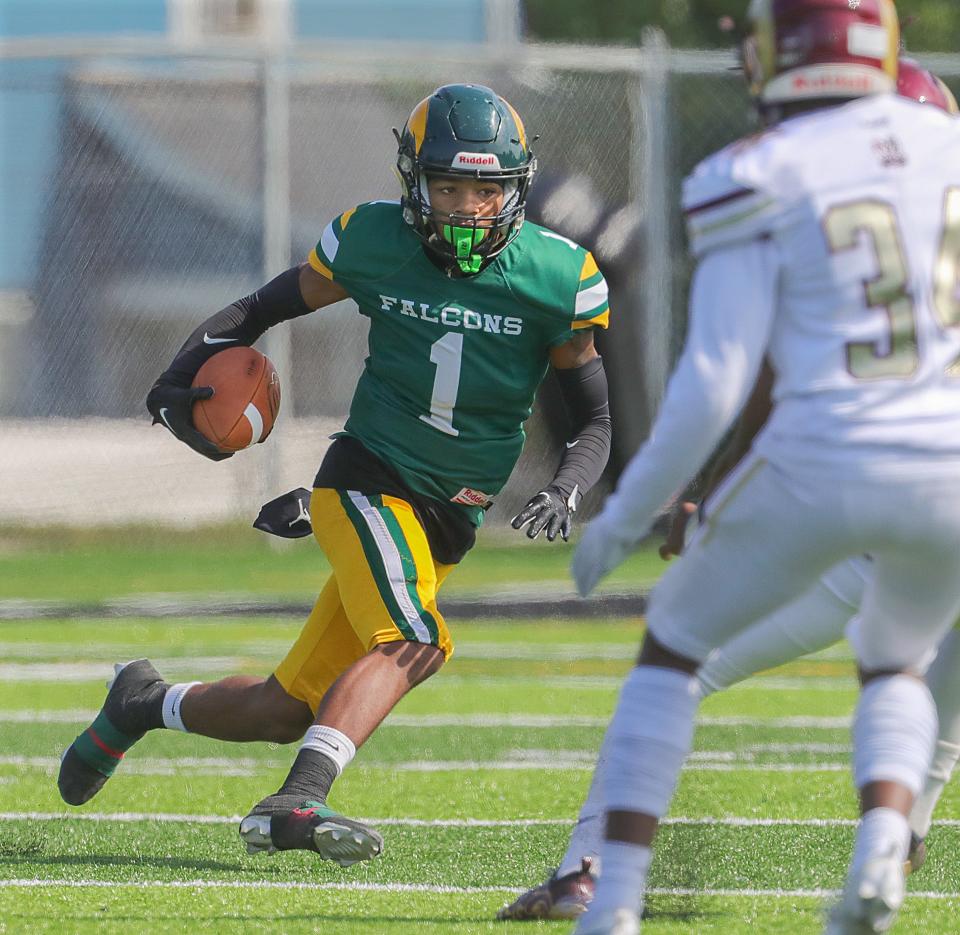 Firestone flanker Juelz Causby runs the ball against Garfield on Sept. 23 in Akron.