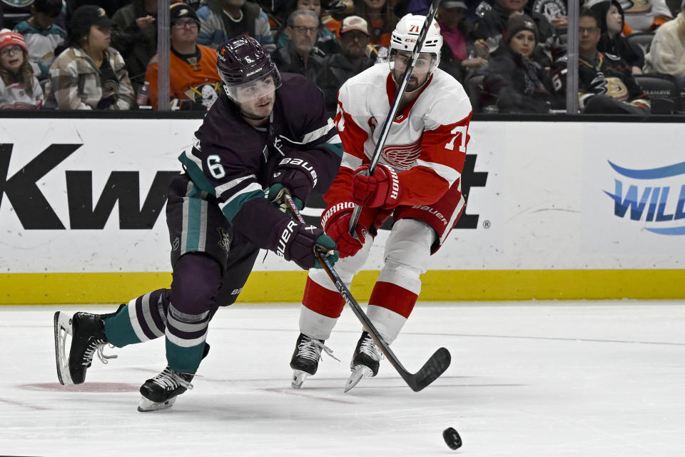 Anaheim Ducks defenseman Jamie Drysdale (6) passes the puck away from Detroit Red Wings center Dylan Larkin (71) during the second period of an NHL hockey game in Anaheim, Calif., Sunday, Jan. 7, 2024. (AP Photo/Alex Gallardo)