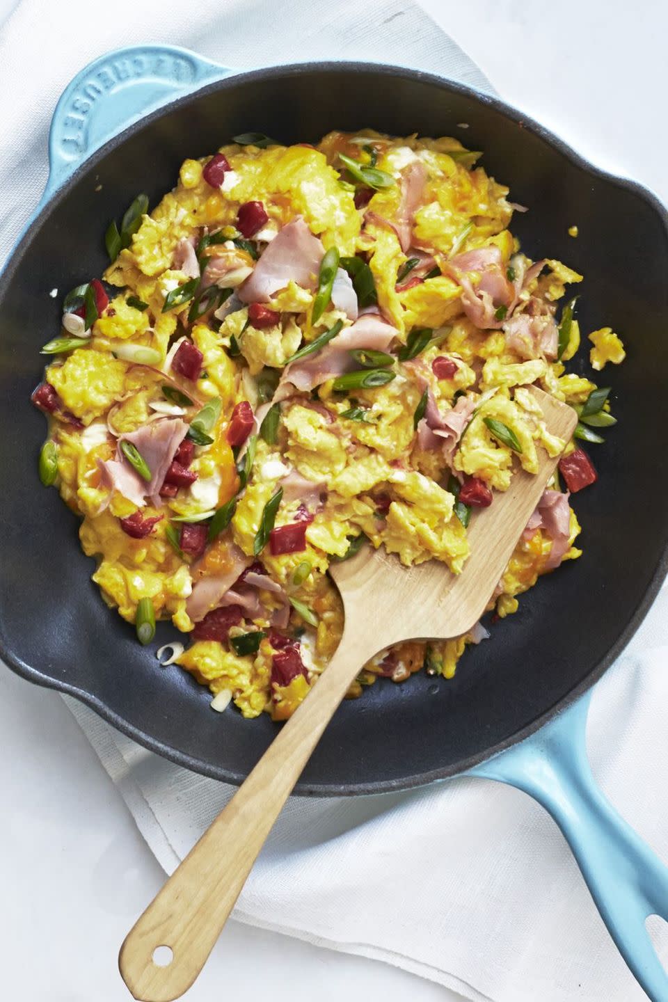 breakfast in bed pimiento, cheese, and ham scramble in skillet with spatula