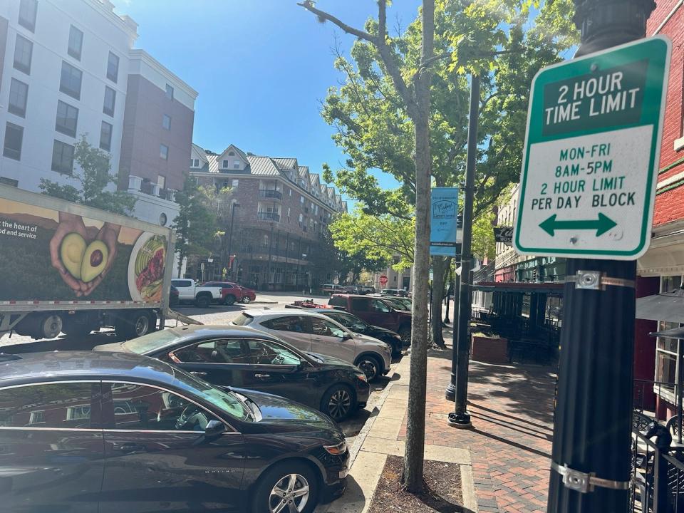 Cars are parked Wednesday morning along Southeast First Street in front of Harry's Seafood Bar & Grille in downtown Gainesville.