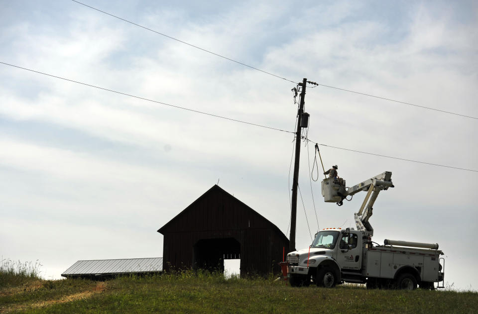 A Gulf Power lineman works to restore a power line in Middleburg, Va., Tuesday, July 3, 2012. Severe storms swept through the area leaving many homes and businesses without electricity. (AP Photo/Cliff Owen)