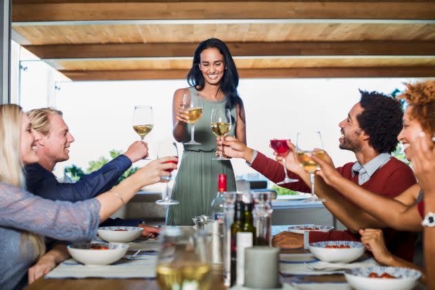 She's secretly thinking about that unchilled white wine you brought to the party. (Photo: Portra Images via Getty Images)