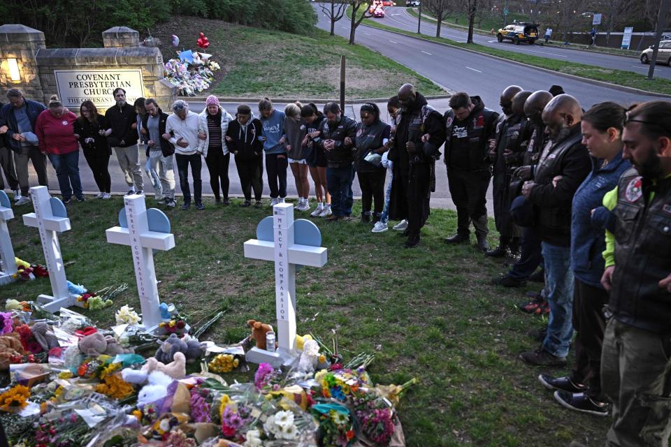Members of the Selected First Motorcycle Club join others in prayer at a makeshift memorial for victims of a shooting at the Covenant School campus, in Nashville, Tennessee, on March 28, 2023.  / Credit: BRENDAN SMIALOWSKI/Getty Images