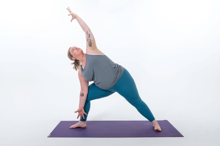 A person demonstrates Extended Side Angle Pose (Utthita Parsvakonasana) in yoga