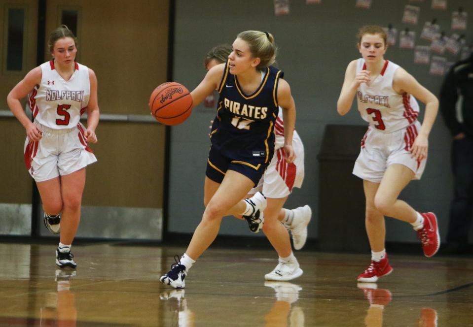 Pewamo-Westphalia's Brooke Spitzley heads downcourt against Laingsburg's Callie Clark and Mallory Woodbury, right, Friday, Jan. 6, 2023, during the first half at Laingsburg.