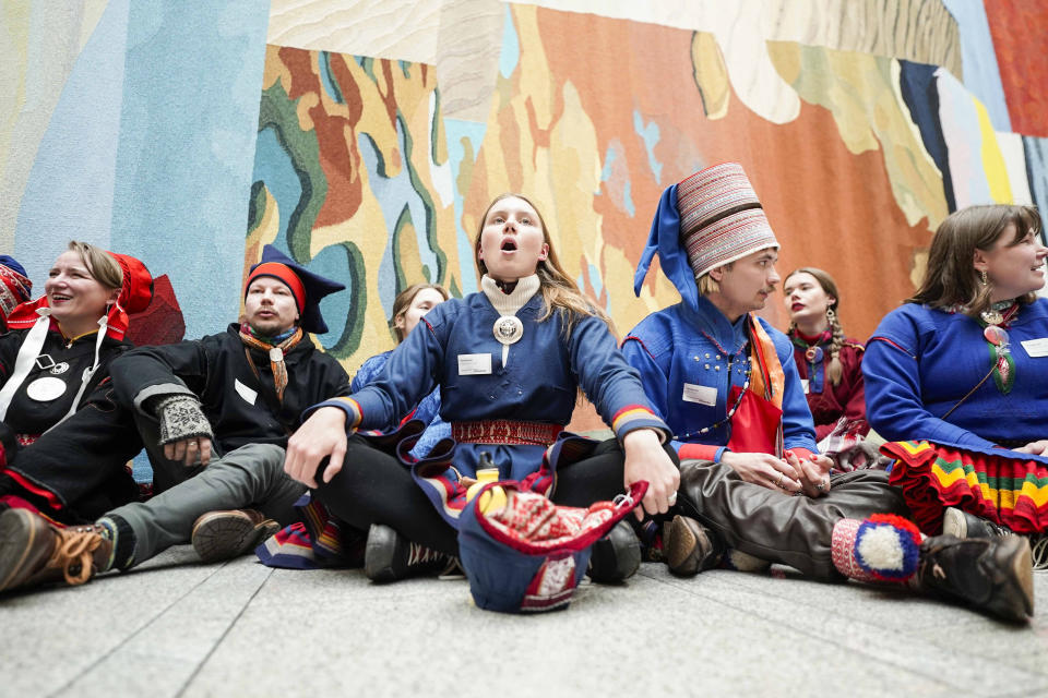 Activists wearing traditional Sami costumes demonstrate inside the central hall of Storting, the Norwegian parliament, in Oslo, Wednesday, Oct. 11, 2023. Dozen of activists, including Indigenous Sami, protested Wednesday saying they are fed up with Norway’s government about a wind farm they want removed in the Fosen district, about 450 kilometers (280 miles) north of Oslo, because they say it endangers the reindeer herders’ way of life. (Håkon Mosvold Larsen/NTB Scanpix via AP)