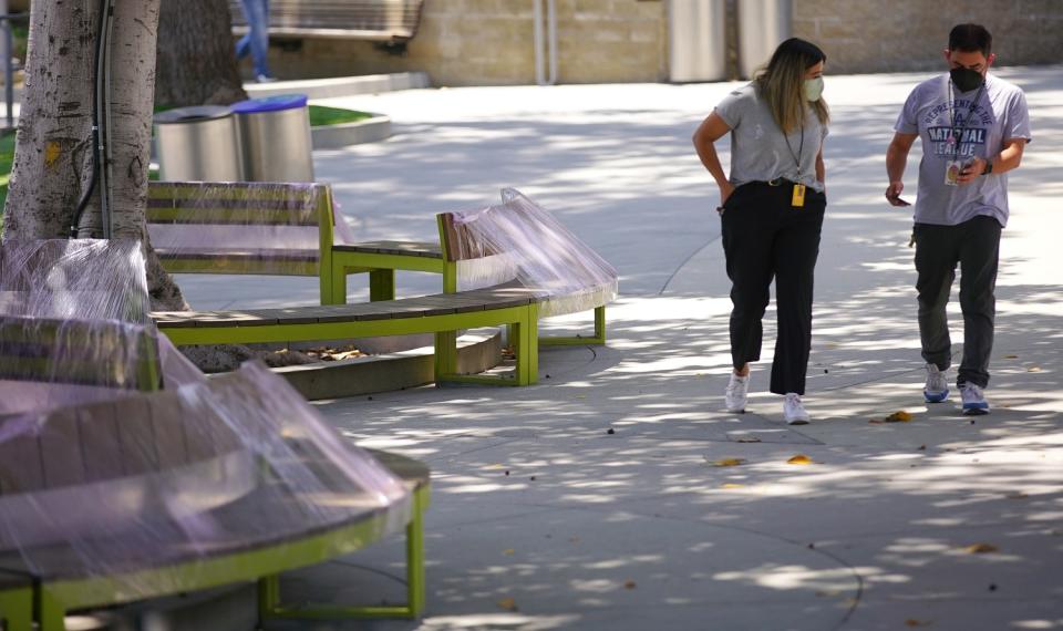 Plastic-wrapped bench seats in a public area of the Hollywood Bowl.