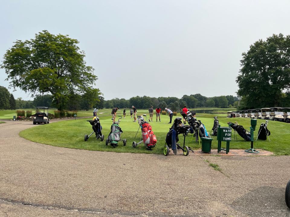 Golfers practice their putts Aug. 1 at the Sanctuary Golf Club in Plain Township after the club's owners announced that the golf course will close in October because it's no longer financially viable.