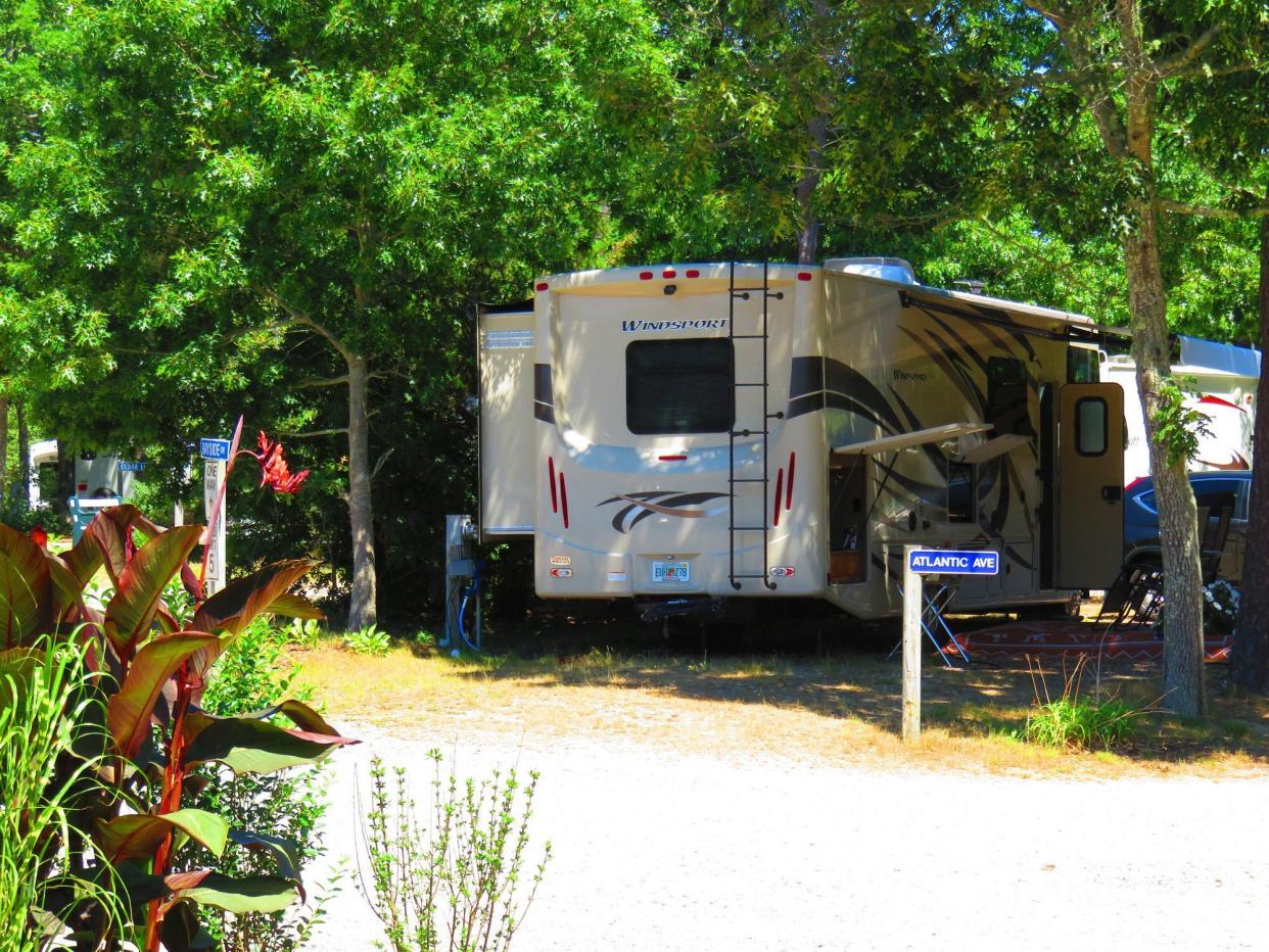 RV in Campground at Atlantic Oaks, Eastham, Massachusetts, RV in center framed by trees and plants