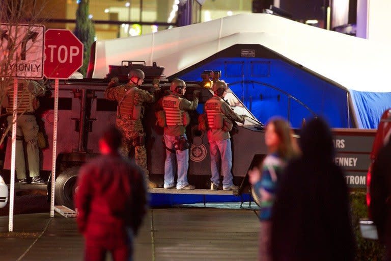 A SWAT team waits outside the Clackamas Town Center during a shooting on December 11, 2012 in Clackamas, Oregon. A large number of emergency vehicles converged on the mall, which was sealed off as nearly 100 officers moved in to secure the scene, looking for people who had hidden or who might be injured