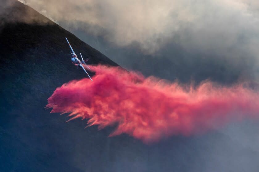 An air tanker makes a drop on the Colorado Fire burning in Big Sur, Calif., on Saturday, Jan. 22, 2022.