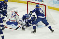 Tampa Bay Lightning goaltender Andrei Vasilevskiy (88) stops a shot by Montreal Canadiens center Nick Suzuki (14) during the first period in Game 1 of the NHL hockey Stanley Cup finals, Monday, June 28, 2021, in Tampa, Fla. (AP Photo/Gerry Broome)