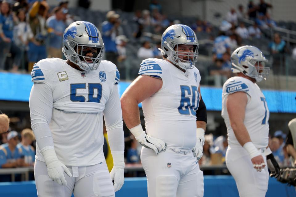 Detroit Lions offensive lineman Penei Sewell, left, and Graham Glasgow look on during warmups before the game against the Los Angeles Chargers at SoFi Stadium on Nov. 12, 2023 in Inglewood, Calif.