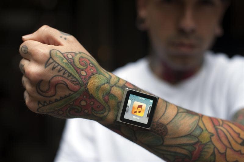Tattoo artist Dave Hurban displays an iPod Nano, in New York, which he has attached to his arm through magnetic piercings in his wrist.