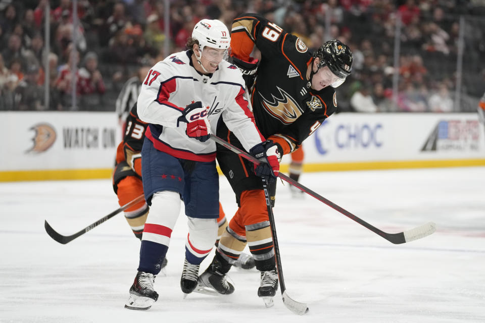 Washington Capitals center Dylan Strome (17) defends against Anaheim Ducks left wing Max Jones (49) during the first period of an NHL hockey game in Anaheim, Calif., Thursday, Nov. 30, 2023. (AP Photo/Ashley Landis)