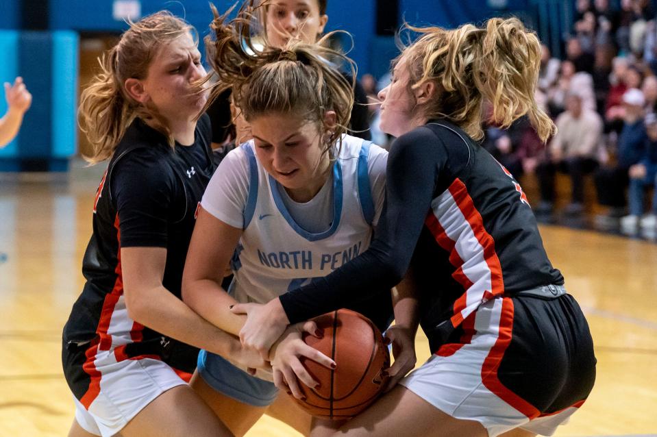Pennsbury's Maggie Burns (2) and Layla Matthias (5) fight North Penn's Caleigh Sperling (4) for a rebound ball during their girls' basketball game in Lansdale on Thursday, Dec. 21, 2023.

Daniella Heminghaus | Bucks County Courier Times
