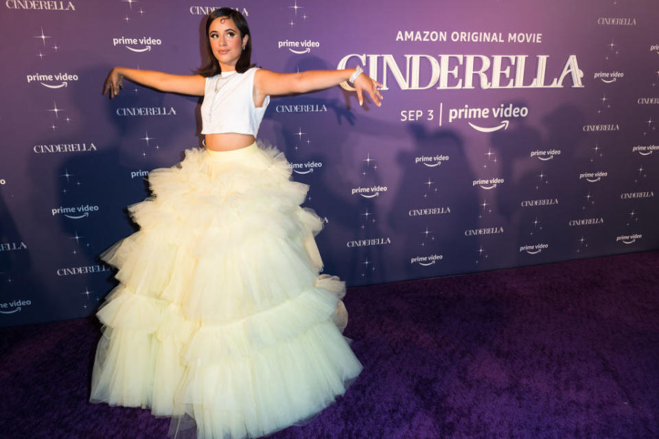 Camila in the tulle floor-length skirt standing with her hands out to the sides