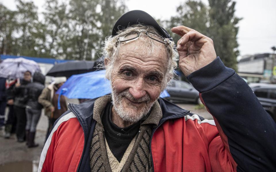 Ukrainians form long queues to receive humanitarian aid in rainy and cold weather in Kupyansk - Metin Aktas/Anadolu Agency via Getty Images