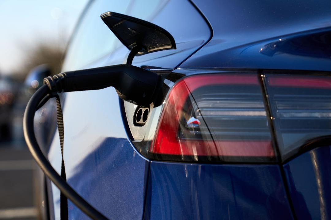 File photo dated 08/03/22 of a Tesla electric vehicle being charged in Hayes, west London. Households with insulation and clean tech such as heat pumps and electric cars are more 