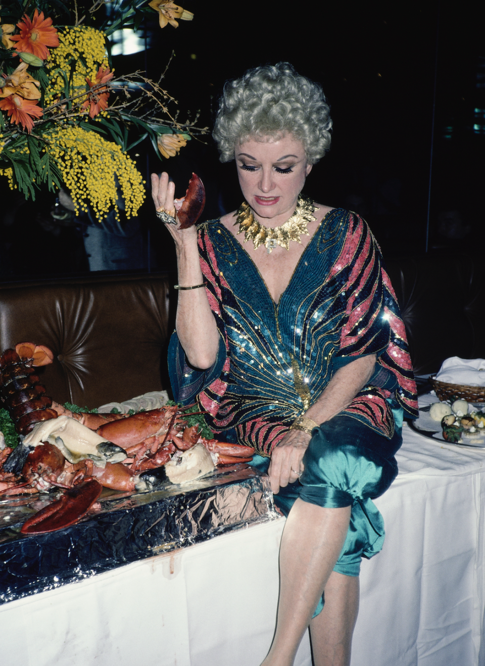 a person sitting at a table with food on it