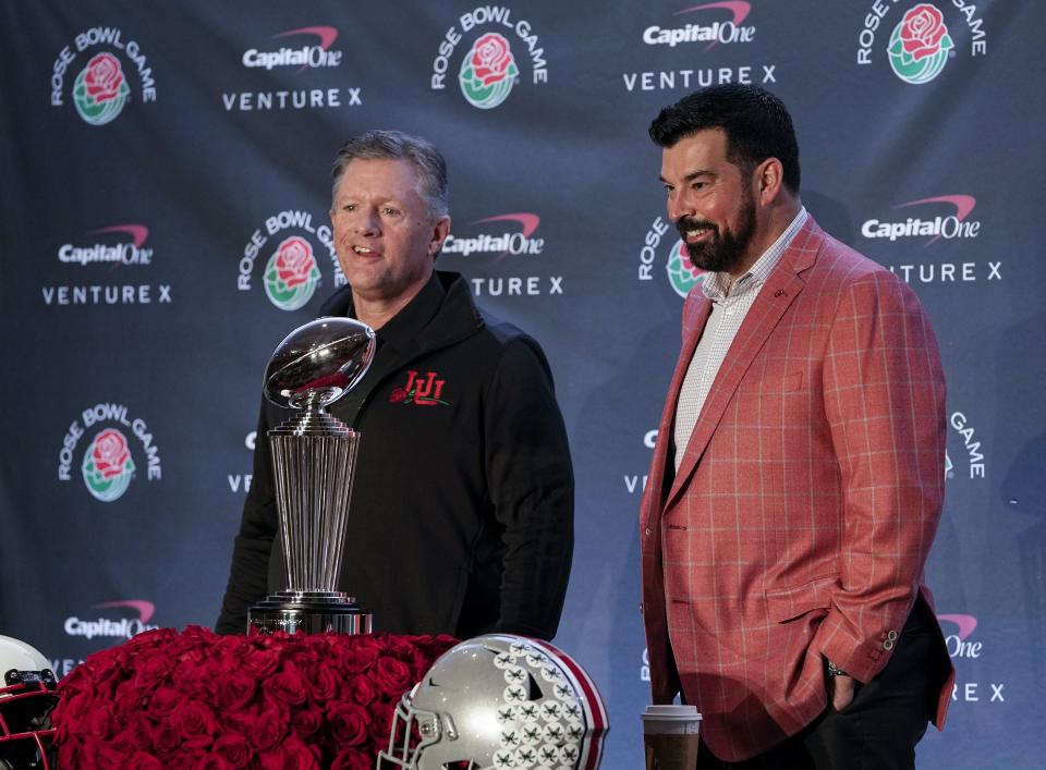 Ohio State Buckeyes head coach Ryan Day and Utah Utes head coach Kyle Whittingham stand with the Rose Bowl trophy during a press conference in Los Angeles on Dec. 31, 2021.