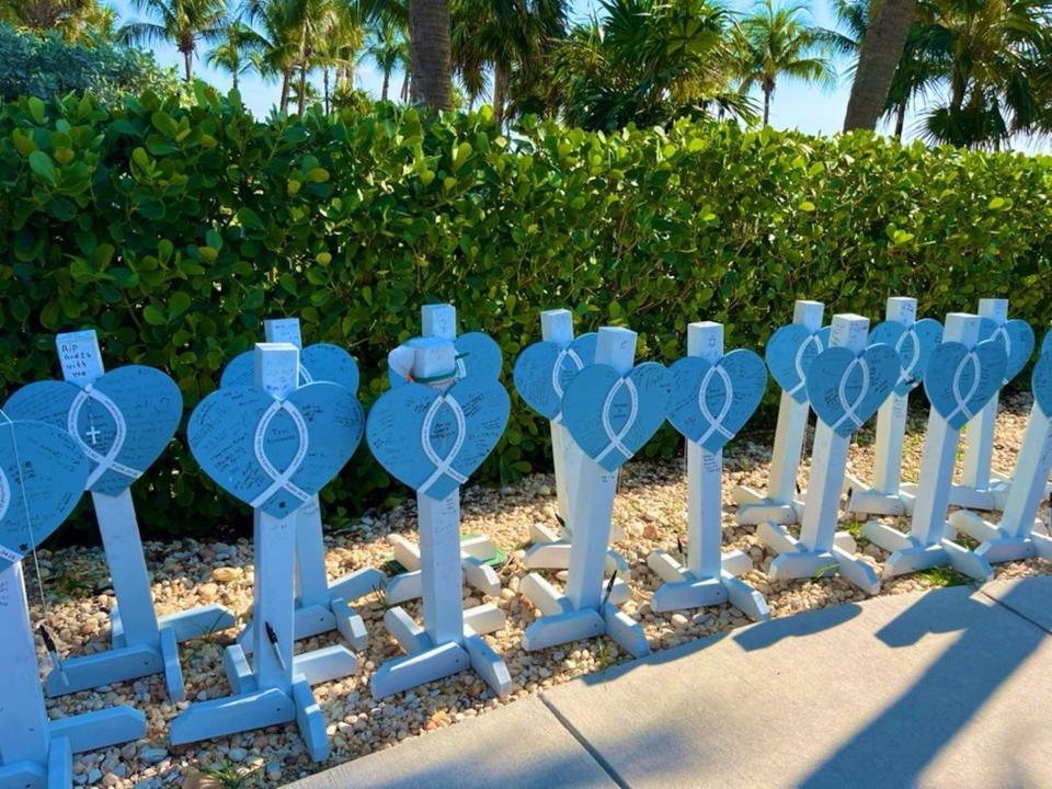 Loved ones wrote notes to those that were lost on headstones outside the ceremony.