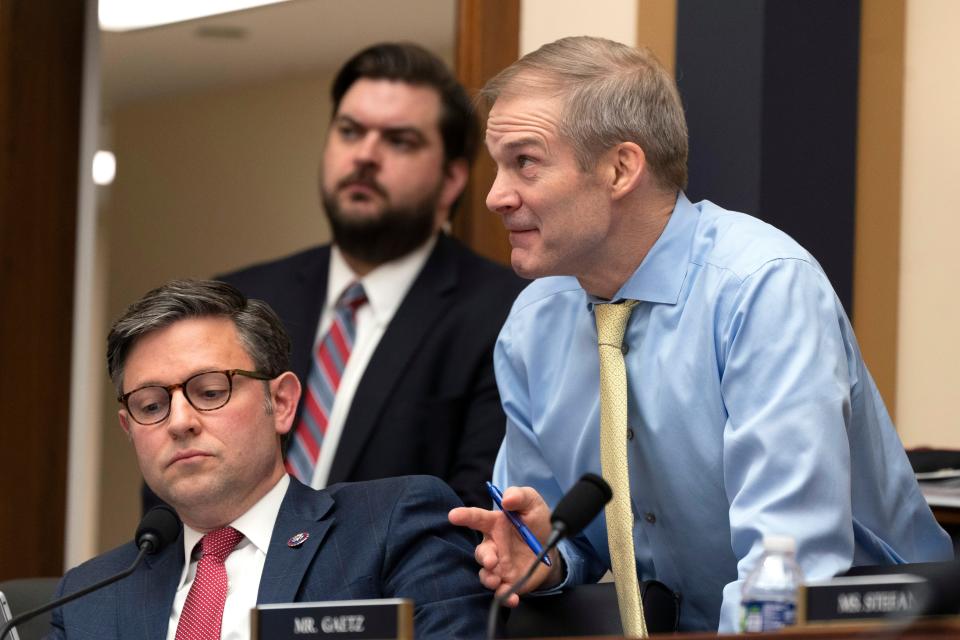 Rep. Jim Jordan, R-Ohio, talks to Rep. Mike Johnson, R-La., during a House Judiciary subcommittee hearing on what Republicans say is the politicization of the FBI and Justice Department and attacks on American civil liberties. on Capitol Hill in Washington on March 9, 2023.