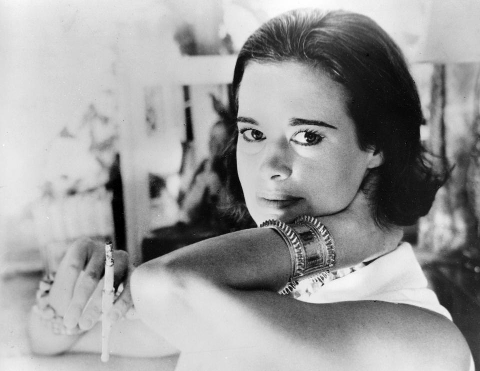 FILE - In this Jan. 4, 1964 file photo, railroad heiress Gloria Vanderbilt poses for a photograph. Vanderbilt, the intrepid heiress, artist and romantic who began her extraordinary life as the "poor little rich girl" of the Great Depression, survived family tragedy and multiple marriages and reigned during the 1970s and '80s as a designer jeans pioneer, died Monday, June 17, 2019, at the age of 95. (AP Photo, File)