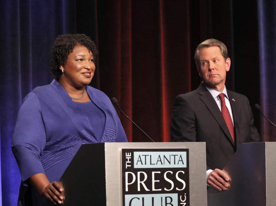 Democratic gubernatorial candidate for Georgia Stacey Abrams, left, speaks as her Republican opponent Secretary of State Brian Kemp looks on during a debate Tuesday, Oct. 23, 2018, in Atlanta. (AP Photo/John Bazemore, Pool)