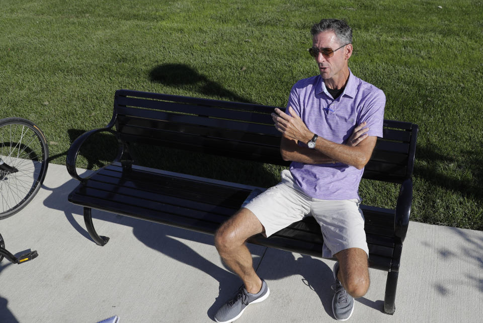 Randall Scott discusses the impeachment inquiry into President Donald Trump while sitting in a park in the Nickel Plate District, Wednesday, Oct. 9, 2019, in Fishers, Ind. (AP Photo/Darron Cummings)