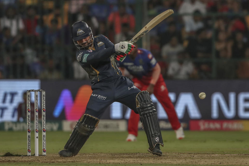 Gujarat Titans' Rashid Khan plays a shot during the Indian Premier League cricket match between Royal Challengers Bengaluru and Gujarat Titans in Bengaluru, India, Saturday, May 4, 2024. (AP Photo)